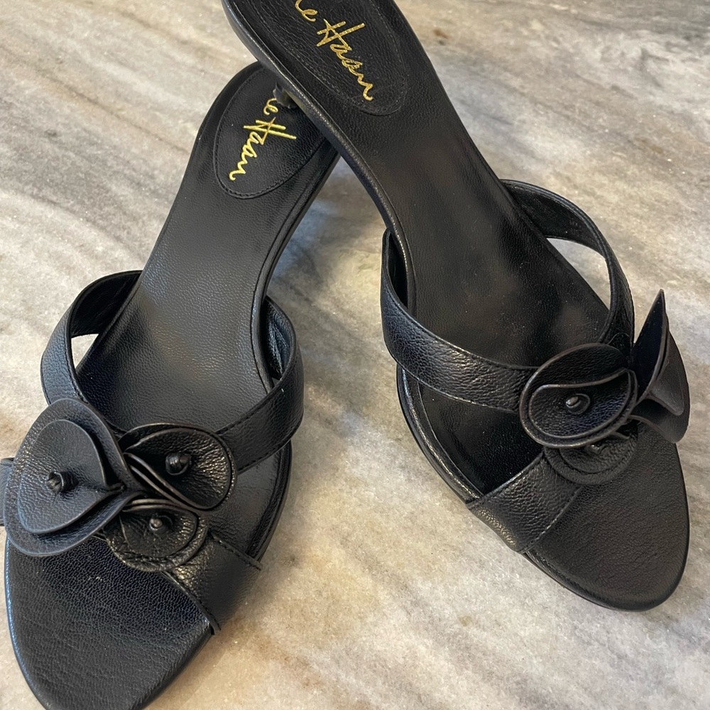 black leather Cole Haan Ronda slide sandals with a floral kitten heel